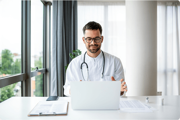 Clinician working at a laptop